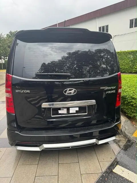Rear view of the black Hyundai Grand Starex Plus