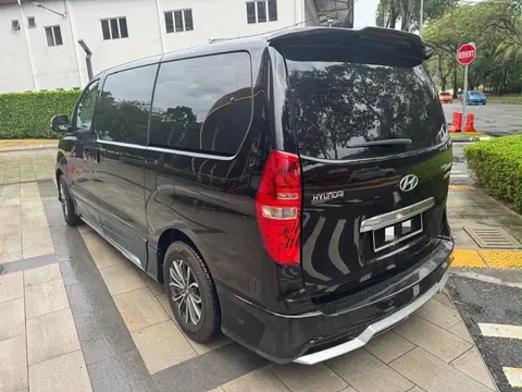 Rear of the Hyundai Grand Starex Plus from the left